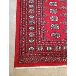 Bokhara Rug. Rich deep red. 204cm by 306cm. 'Elephant's foot' design.