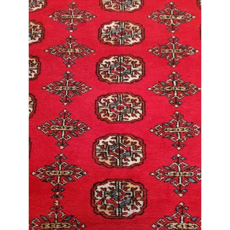 Bokhara Rug. Rich deep red. 204cm by 306cm. 'Elephant's foot' design.