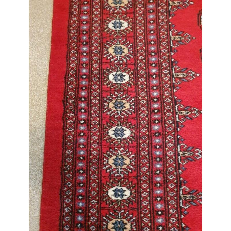 Bokhara Rug. Rich deep red. 204cm by 306cm. 'Elephant's foot' design.